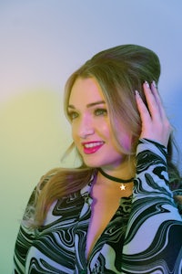 a woman in a black and white shirt posing for a photo
